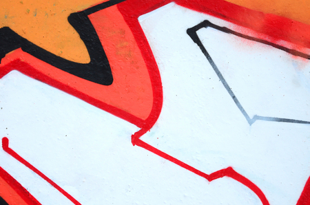 Fragment of colored street art graffiti paintings with contours and shading close up. Background texture of youth contemporary art culture. Orange, red and black coloursのeditorial素材