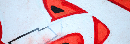 Fragment of colored street art graffiti paintings with contours and shading close up. Background texture of youth contemporary art culture. Orange, red and black coloursのeditorial素材