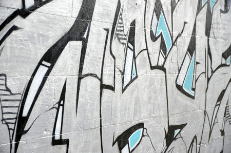 Fragment of colored street art graffiti paintings with contours and shading close up. Background texture of youth contemporary art culture. Blue and chrome colorsのeditorial素材