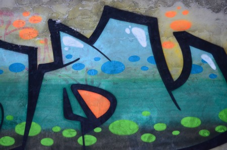 Fragment of colored street art graffiti paintings with contours and shading close up. Background texture of youth contemporary art culture. Green and yellow coloursのeditorial素材