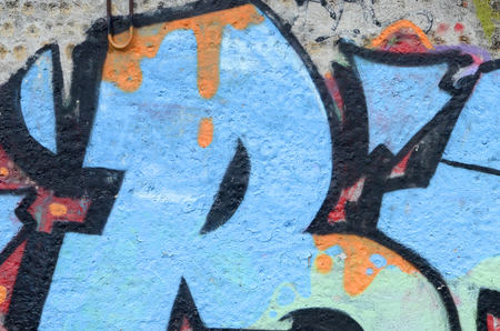 Fragment of colored street art graffiti paintings with contours and shading close up. Background texture of youth contemporary art culture. Blue orange and black colorsのeditorial素材