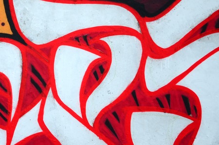 Fragment of colored street art graffiti paintings with contours and shading close up. Background texture of youth contemporary art culture. Orange, red and black coloursのeditorial素材