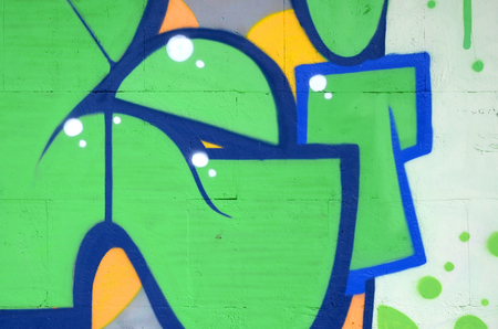 Fragment of colored street art graffiti paintings with contours and shading close up. Background texture of youth contemporary art culture. Green and yellow coloursのeditorial素材