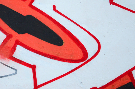 Fragment of colored street art graffiti paintings with contours and shading close up. Background texture of youth contemporary art culture. Orange, red and black coloursのeditorial素材