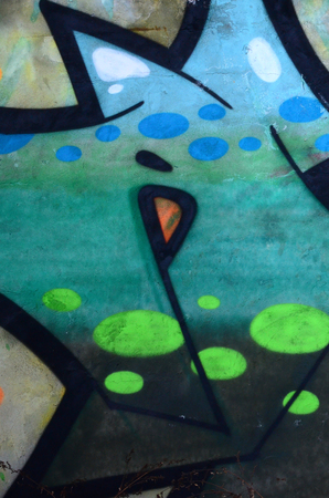 Fragment of colored street art graffiti paintings with contours and shading close up. Background texture of youth contemporary art culture. Green and yellow coloursのeditorial素材