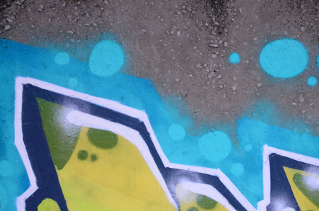 Fragment of colored street art graffiti paintings with contours and shading close up. Background texture of youth contemporary art culture. Green and yellow coloursのeditorial素材