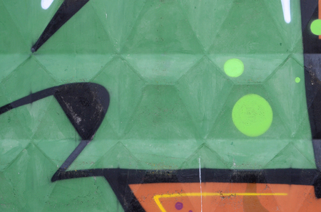 Fragment of colored street art graffiti paintings with contours and shading close up. Background texture of youth contemporary art culture. Green yellow colorsのeditorial素材
