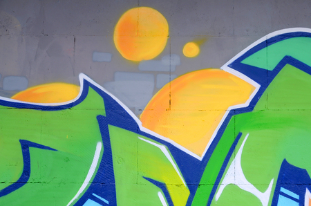 Fragment of colored street art graffiti paintings with contours and shading close up. Background texture of youth contemporary art culture. Green and yellow coloursのeditorial素材