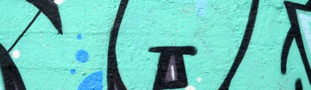 Fragment of colored street art graffiti paintings with contours and shading close up. Background texture of youth contemporary art culture. Turquoise green colorsのeditorial素材