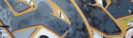 Fragment of colored street art graffiti paintings with contours and shading close up. Background texture of youth contemporary art culture. Grey and orange colorsのeditorial素材