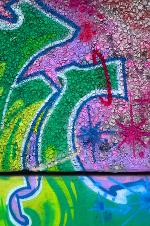 Fragment of colored street art graffiti paintings with contours and shading close up. Background texture of youth contemporary art culture. Green and yellow coloursのeditorial素材