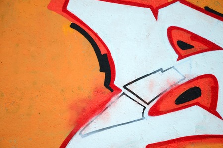 Fragment of colored street art graffiti paintings with contours and shading close up. Background texture of youth contemporary art culture. Orange, red and black coloursのeditorial素材