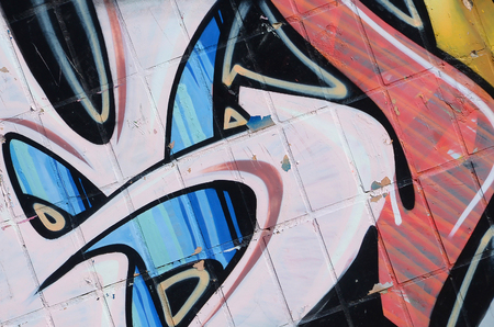 Fragment of colored street art graffiti paintings with contours and shading close up. Background texture of youth contemporary art culture. Yellow orange and brown colorsのeditorial素材