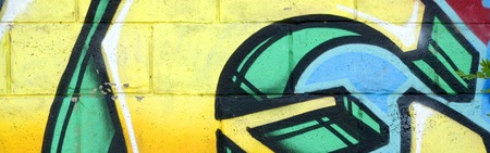 Fragment of colored street art graffiti paintings with contours and shading close up. Background texture of youth contemporary art culture. Yellow orange and brown colorsのeditorial素材