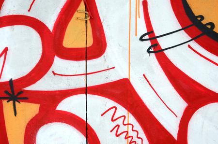 Fragment of colored street art graffiti paintings with contours and shading close up. Background texture of youth contemporary art culture. Orange, red and black coloursのeditorial素材