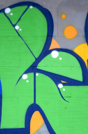 Fragment of colored street art graffiti paintings with contours and shading close up. Background texture of youth contemporary art culture. Green and yellow coloursのeditorial素材