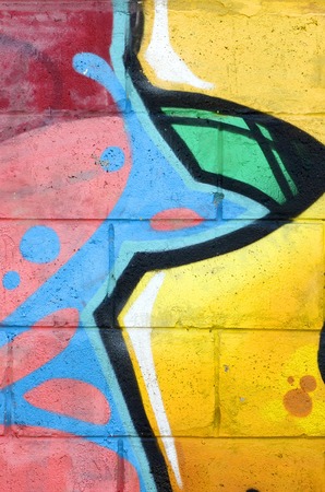 Fragment of colored street art graffiti paintings with contours and shading close up. Background texture of youth contemporary art culture. Yellow orange and brown colorsのeditorial素材