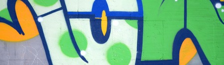 Fragment of colored street art graffiti paintings with contours and shading close up. Background texture of youth contemporary art culture. Green and yellow coloursのeditorial素材