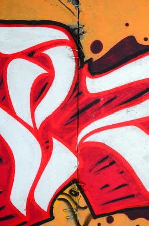 Fragment of colored street art graffiti paintings with contours and shading close up. Background texture of youth contemporary art culture. Orange, red and black coloursのeditorial素材