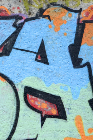 Fragment of colored street art graffiti paintings with contours and shading close up. Background texture of youth contemporary art culture. Blue orange and black colorsの写真素材