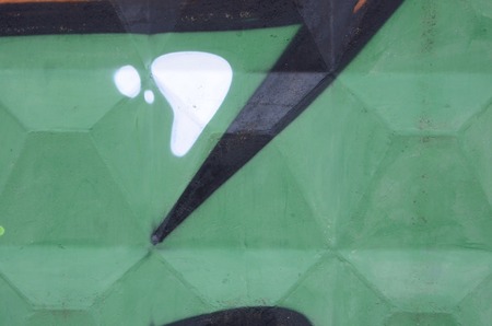 Fragment of colored street art graffiti paintings with contours and shading close up. Background texture of youth contemporary art culture. Green yellow colorsの写真素材