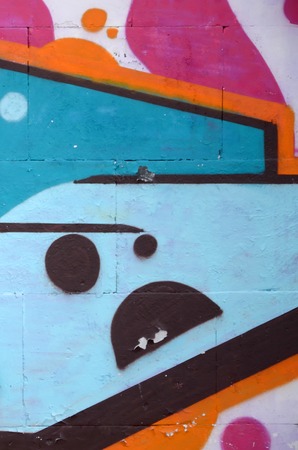 Fragment of colored street art graffiti paintings with contours and shading close up. Background texture of youth contemporary art culture. Blue orange and black colorsの写真素材