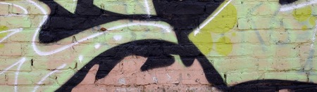 Fragment of colored street art graffiti paintings with contours and shading close up. Background texture of youth contemporary art culture. Green yellow colorsの写真素材