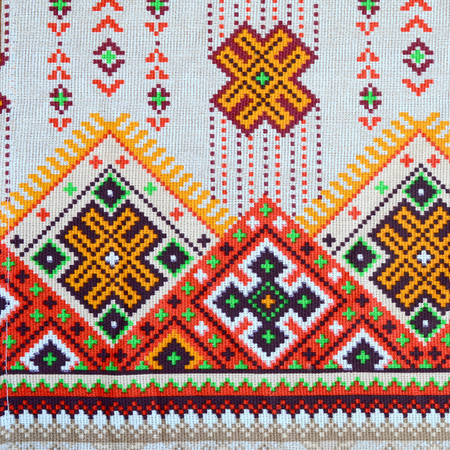 Traditional Ukrainian folk art knitted embroidery pattern on textile fabric. Colored pixel design knitted canvas.の写真素材