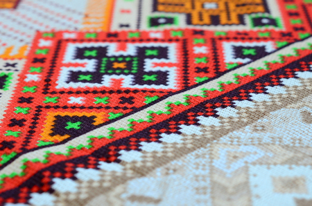 Traditional Ukrainian folk art knitted embroidery pattern on textile fabric. Colored pixel design knitted canvas.の写真素材