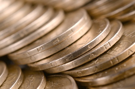 Large pile of big golden coins. Financial success money background for rich life concepts, banking and profit in Ukraineの写真素材