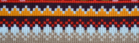 Traditional Ukrainian folk art knitted embroidery pattern on textile fabric. Colored pixel design knitted canvas.の写真素材