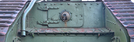 Texture of tank side wall, made of metal and reinforced with a multitude of bolts and rivets. Image...
