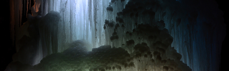 Huge ice icicles. Fragment of large blocks of ice frozen waterfall of water. Blue ice cavern background. Frozen stream waterfallの写真素材