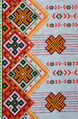 Traditional Ukrainian folk art knitted embroidery pattern on textile fabric. Colored pixel design...