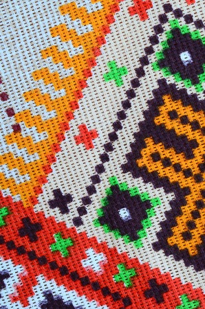 Traditional Ukrainian folk art knitted embroidery pattern on textile fabric. Colored pixel design...