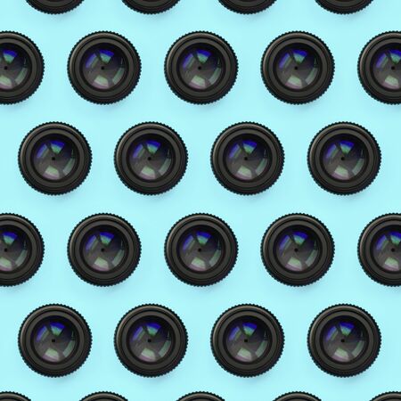 A few camera lenses with a closed aperture lie on texture background of fashion pastel blue color paper in minimal concept. Abstract trendy pattern.の写真素材