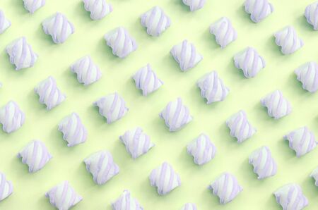 Colorful marshmallow laid out on lime paper background. pastel creative textured pattern. minimal.の写真素材
