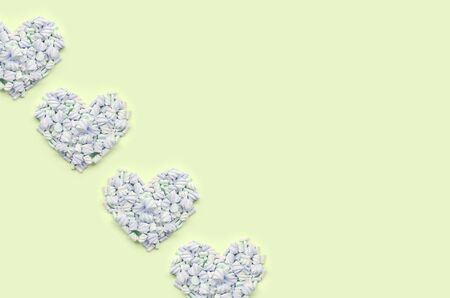 Colorful marshmallow laid out on lime and pink paper background. pastel creative textured hearts. minimal.の写真素材