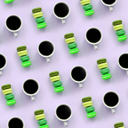 A pattern of many colorful dessert cake macaroon and coffee cups on trendy pastel lilac background top view. Flat lay composition.の写真素材