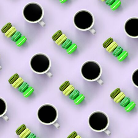A pattern of many colorful dessert cake macaroon and coffee cups on trendy pastel lilac background top view. Flat lay composition.の写真素材