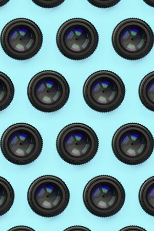 A few camera lenses with a closed aperture lie on texture background of fashion pastel blue color paper in minimal concept. Abstract trendy pattern.の写真素材