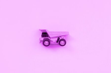 Small purple toy truck on texture background of fashion pastel purple color paper in minimal concept.の写真素材