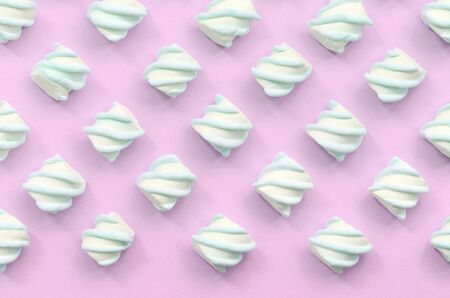 Colorful marshmallow laid out on pink paper background. pastel creative textured pattern. minimal.の写真素材