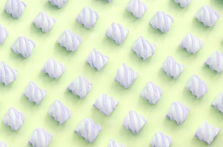 Colorful marshmallow laid out on lime paper background. pastel creative textured pattern. minimal.の写真素材