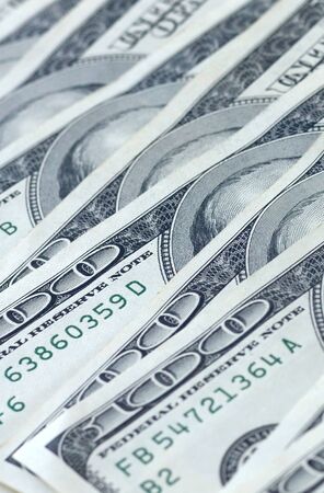 Background of 100 dollar bills. Abstract textured backdrop with many hundred money bills. Rich life...