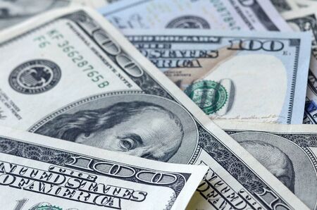 Background of 100 dollar bills. Abstract textured backdrop with many hundred money bills. Rich life...