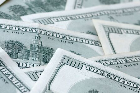 Background of 100 dollar bills. Abstract textured backdrop with many hundred money bills. Rich life...