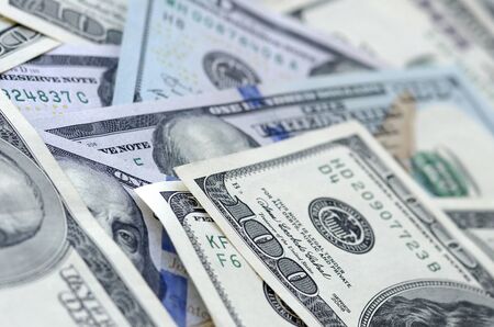 Background of 100 dollar bills. Abstract textured backdrop with many hundred money bills. Rich life...