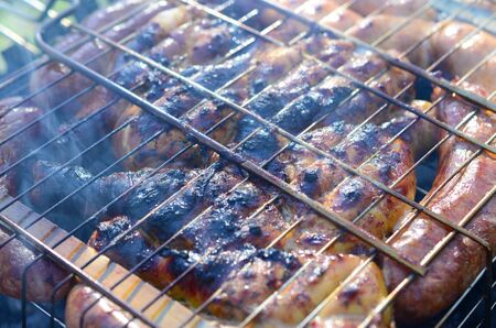 Toasted meat with overcooked crust. Marinated Chicken Legs On The Hot BBQ Charcoal Grill Poor and improper cooking meat on fireの写真素材