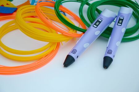 Top view on 3d pen and kit of colourful ABS plastic filament on white background.